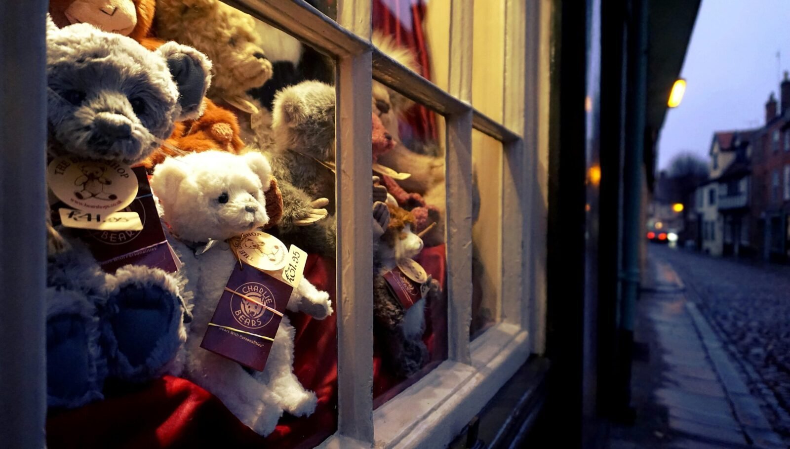 Cozy shop window with teddy bears in Norfolk, England. Perfect for home décor and gift ideas.